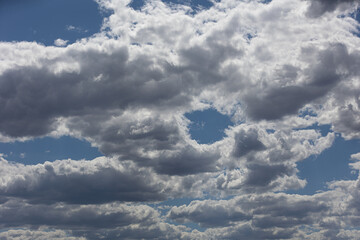 Puffy white clouds against a bright blue sky