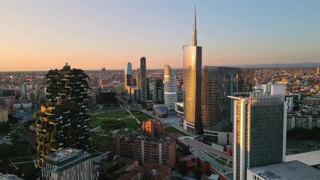 aerial view drone milan city business district at sunrise pan,modern town financial area at dawn panning