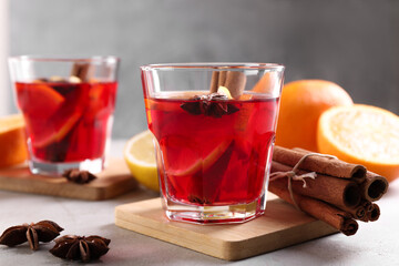 Aromatic punch drink and ingredients on white table