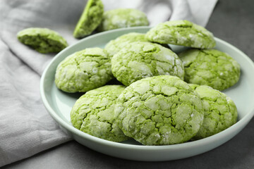 Plate with tasty matcha cookies on grey table, closeup