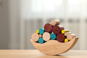 Wooden balance toy on table indoors, closeup. Space for text. Children's development
