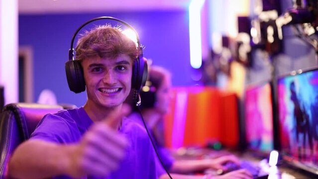 video portrait of young gamer boy ready to play online with his headset and neon blurred backgroundProyecto sin título 12
