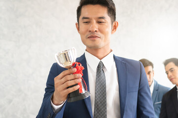 Asian businessman proud with his prize achievement in career award