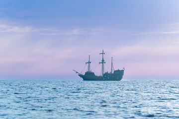 seascape with pirate ship during sunset
