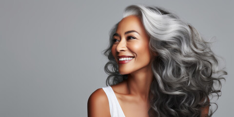 Close up beautiful black female with smooth healthy face skin. Gorgeous aging mature african american woman with long gray hair and happy smiling - Powered by Adobe