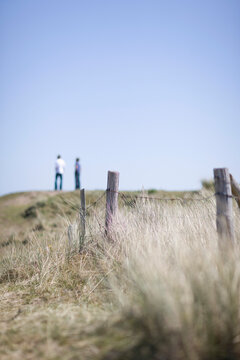 Grass with two people standing in the distance
