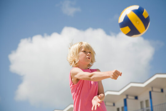 Blonde boy playing volleyball
