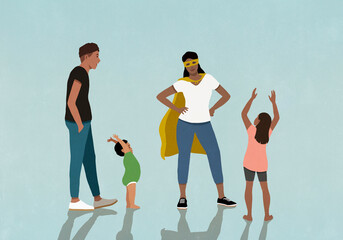 Family cheering for mother in superhero cape
