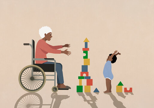 Senior grandmother in wheelchair watching happy baby boy playing with toy blocks
