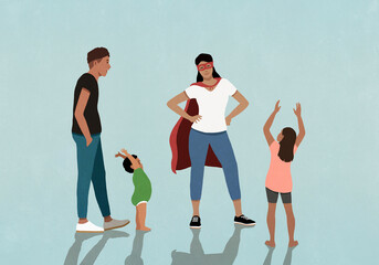 Family cheering for mother in superhero cape