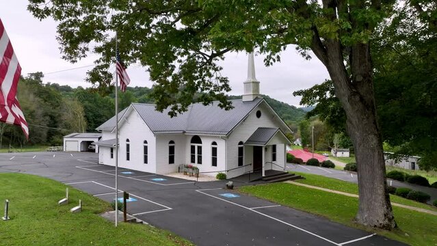 church aerial in zionville nc, north carolina, zionville baptist with american flags in foreground