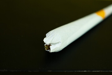 Close up cigarette handmade isolated on black background