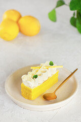 Lemon cake with whipped cream on the light table.