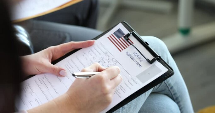Group of people fills out American visa application form. Immigration and relocation to USA concept