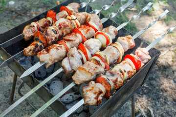 Cooking barbecue with vegetables on skewers. Roasted meat on the grill