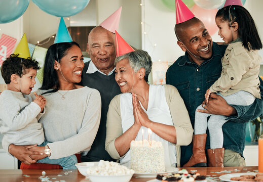 Happy birthday, grandma or family in home for celebration, bond or growth together. Smile, hat or excited grandparents with cake, love or children siblings in a fun house party or special event