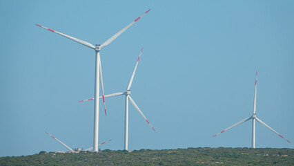 Wind turbines placed on mountains on sunny morning