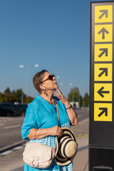 tourist senior woman looking on arrows thinking and feeling lost and confused