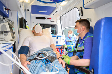 Paramedic is near a patient in an ambulance