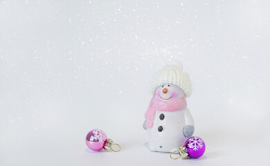 snowman and christmas balls on a  shiny  white background
