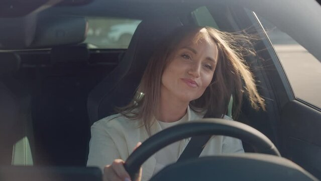 Contented lady expressing satisfaction while driving car