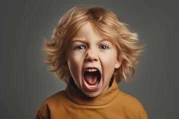 Foto op Canvas A young boy with his mouth open wide in surprise or excitement. This image can be used to depict astonishment, curiosity, or amazement. © Fotograf