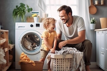 happy family father and his kid doing laundry together at home - obrazy, fototapety, plakaty