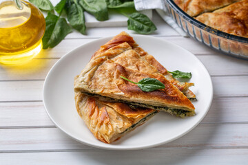 Spanakopita, greek phyllo pastry pie with spinach and feta cheese filling. Delicious handmade pies. Turkish name; el acmasi borek
