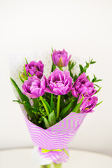 bouquet of beautiful violet lush tulips in a vase