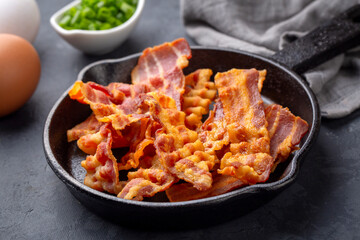 Delicious fried bacon served on plate.