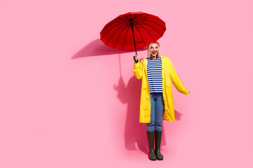 Full length photo of funky pretty woman dressed rain coat walking under parasol empty space...