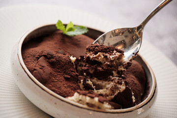 Dolce Delight: A luscious serving of tiramisu, its layers of delicate mascarpone, coffee-soaked ladyfingers, and dusting of cocoa creating a heavenly blend of flavors and textures, a dessert that embo