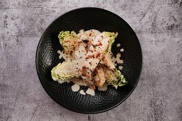 Chicken Fillets & Caesar Charm: Juicy chicken fillets meet crisp Caesar salad, a delightful union of flavors and textures, embodying freshness and indulgence on a single plate.