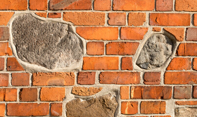 Granite stones set into medieval brick wall, detail, architecture - Gniezno, Poland