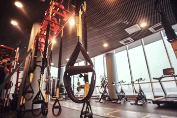 Foto op Canvas Interior and equipment in the modern gym, close-up view of suspension straps. © Dil