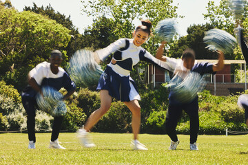 Cheerleader team, blur and people dance in performance on field outdoor for exercise, training and...
