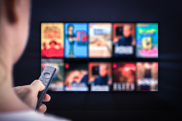 Tv online. Television streaming video. hand holding TV remote control. Multimedia streaming concept. VoD content provider. Video service with internet streaming multimedia shows, series.