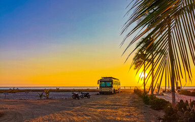 Camper bus car at sunset in Puerto Escondido Oaxaca Mexico. - obrazy, fototapety, plakaty