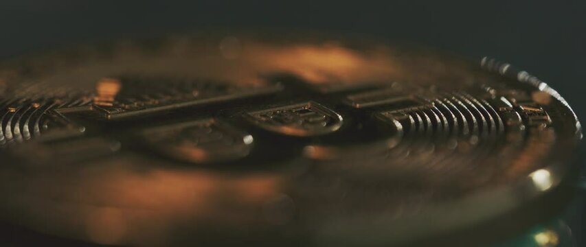 Camera comes into focus to reveal close-up of the digital cryptocurrency Bitcoin