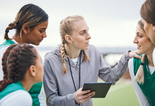 Coach, sports women or team planning tactics or strategy in a hockey training game, conversation or match. Tablet, talking or athletes in practice for fitness exercise together for teamwork in group