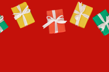 seamless holiday pattern. multi-colored gifts on a red background. flat lay. christmas, birthday or holiday concept