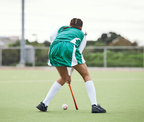 Obraz premium Hockey, athlete and woman running in game, tournament or competition with ball and stick on grass. Sports, back of player and action play in training, exercise or workout with gear on field ground