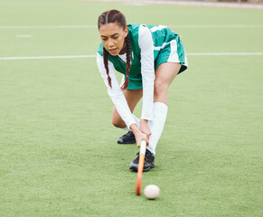 Hockey, sports or girl on turf in fitness training, game or competition with ball, stick or action. Strong woman, athlete or female player in exercise, workout or motion on artificial grass for power