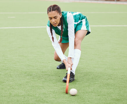 Hockey, sports or girl on turf in fitness training, game or competition with ball, stick or action. Strong woman, athlete or female player in exercise, workout or motion on artificial grass for power