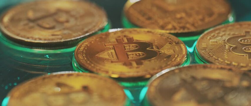 Golden Bitcoin on blur background with flames over them. Extreme close-up