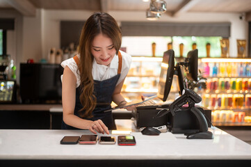 An Asian young Cashier woman working in supermarket