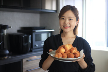 手作りのサーターアンダギーを持つ女性