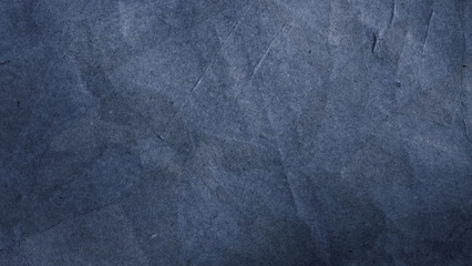 Black dark blue texture background for design. Toned rough concrete surface. A painted old paper. Wide banner.