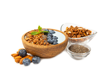 Granola bowl with fresh berries, spirulina and chia seeds isolated on white background. Healthly food. Tasty breakfast. Yogurt with strawberries, raspberries, blueberries, peaches, mint and mendal.