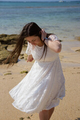 Fototapeta na wymiar girl on the beach in a short wedding dress
